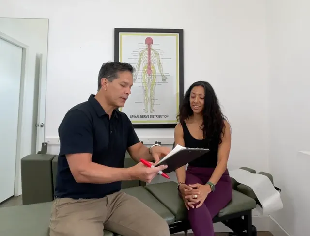 Espinoza Chiropractic doctor reviewing a treatment plan with a patient in Austin, TX